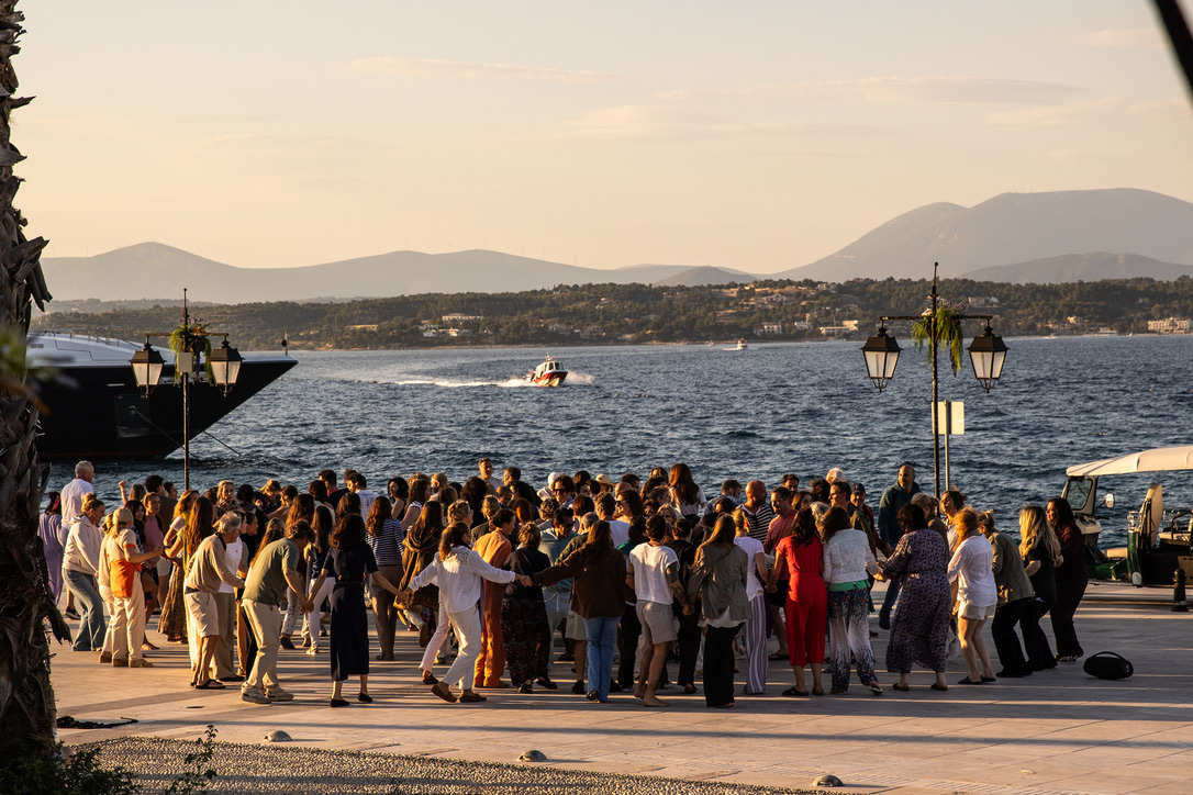The full circle dancing on the Spetses waterfront at golden hour