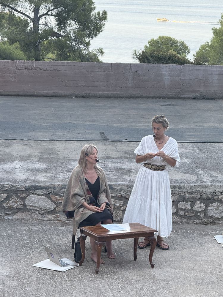 Two facilitators in dialogue by the sea